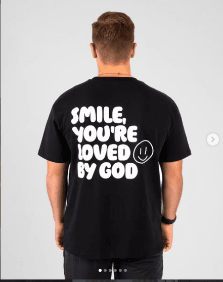 Black tee reading Smile, you're loved by God