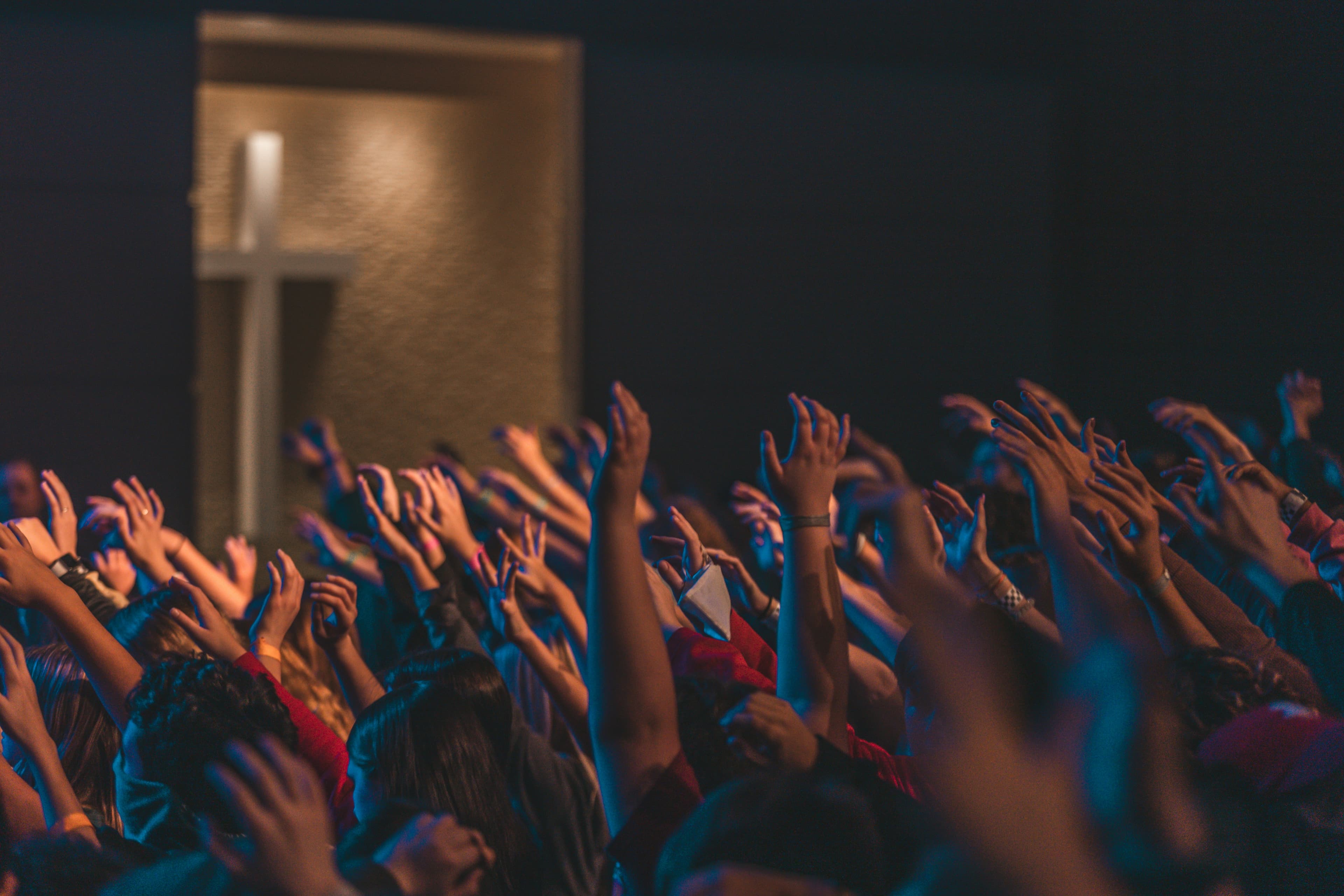 Hands raised in worship at a gathering